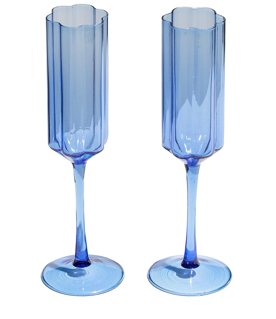 Two blue champagne flutes on a white background