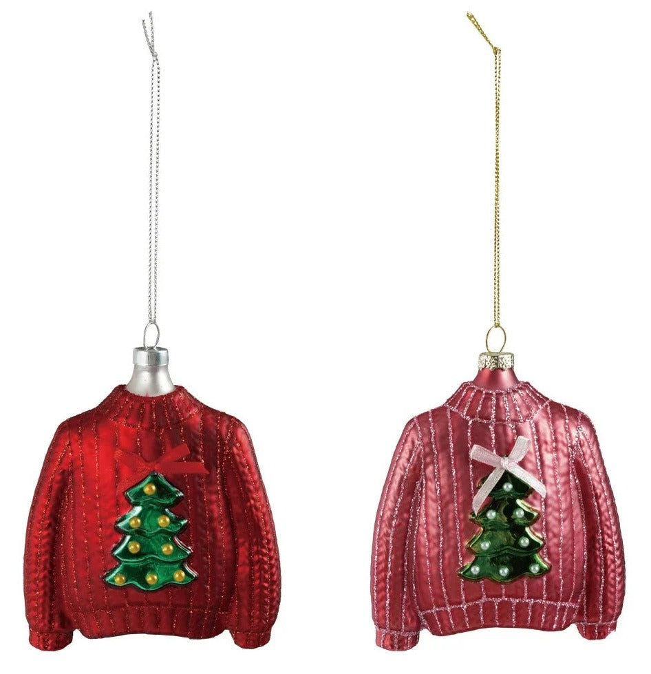 Two red sweater ornaments with Christmas tree designs on a white background