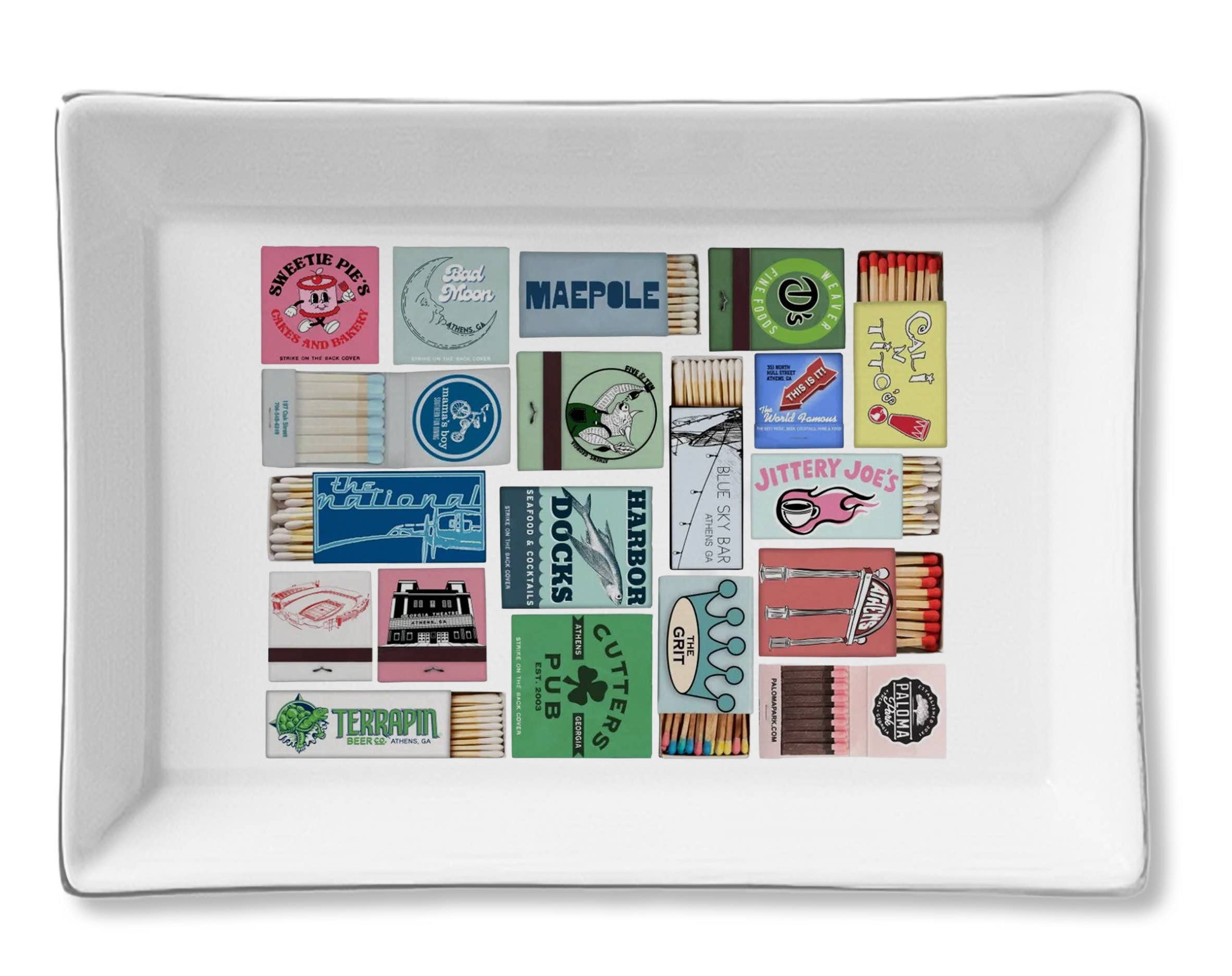 White rectangular tray with colorful matchbook designs on a white background