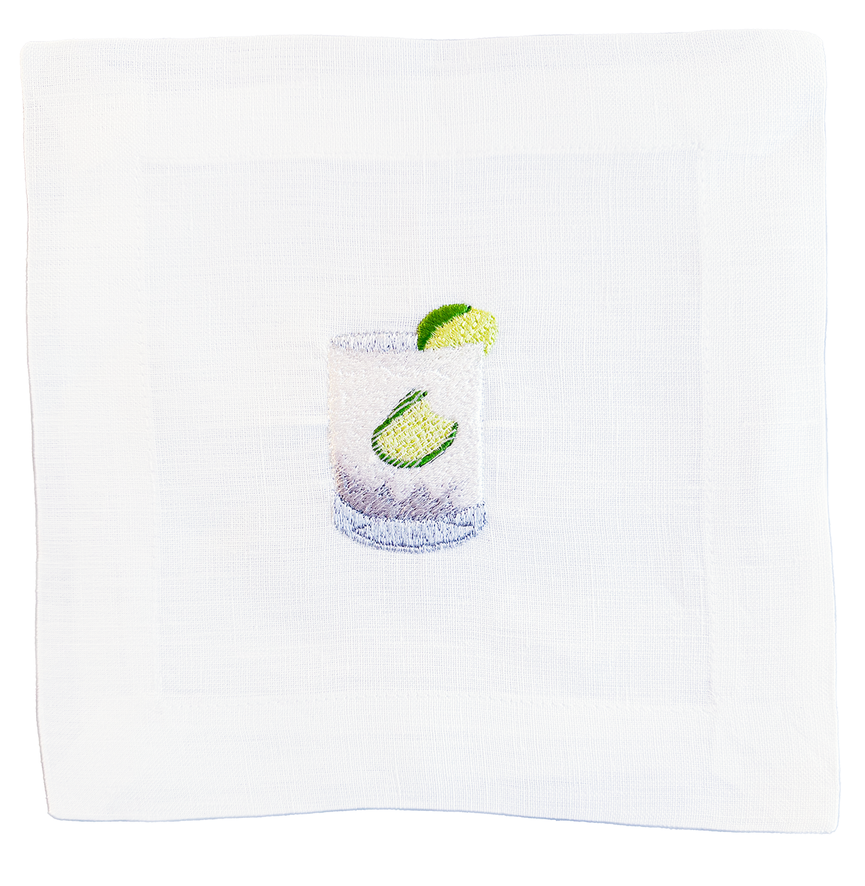 Cocktail with lime wedges in a glass on a white napkin