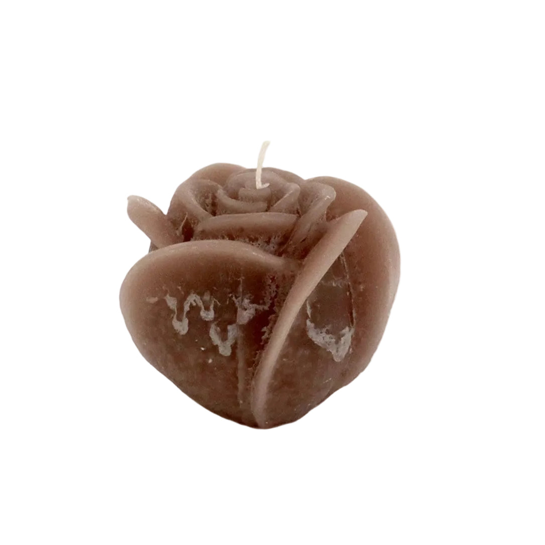 Rose-shaped candle with 'LOVE' engraving on a white background