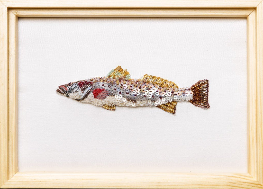 Framed artwork of a fish on a dark background