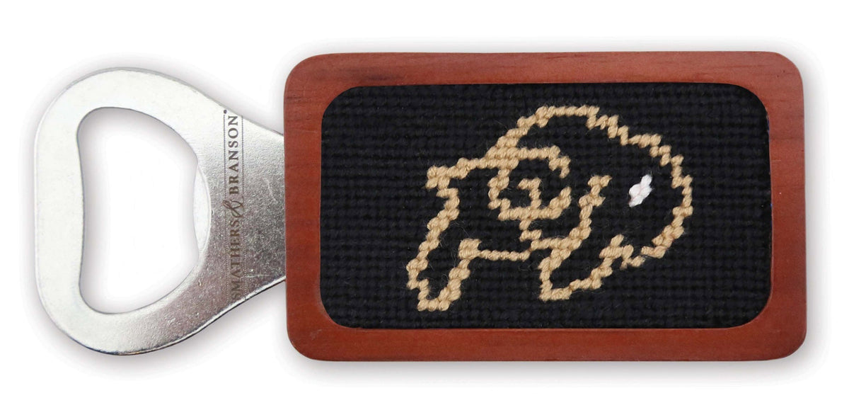 Bottle opener with needlepoint design on a white background