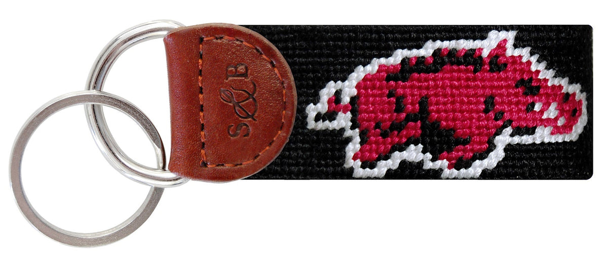 Keychain with a red and black logo on a white background