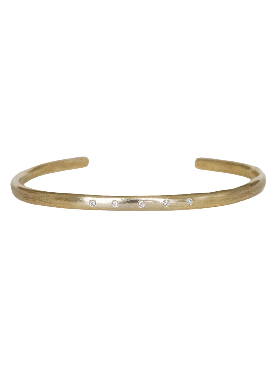 Gold bracelet with small stones on a white background