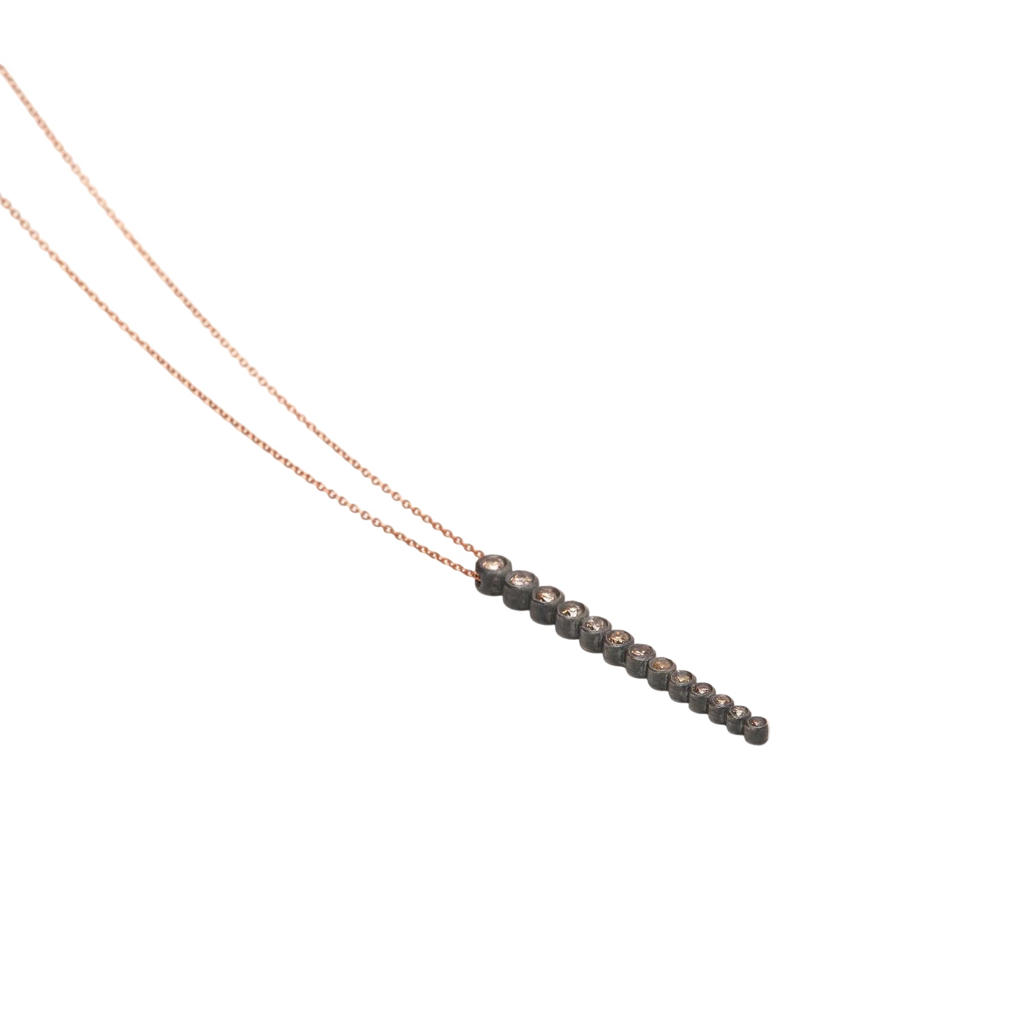 Necklace with small beads on a thin chain against a white background