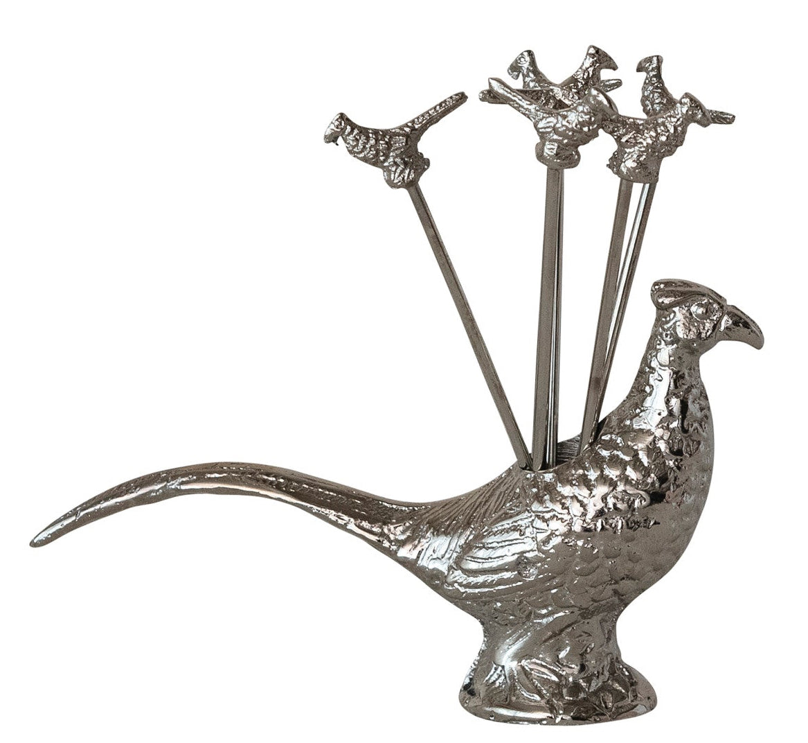 Decorative silver peacock with skewers on a white background
