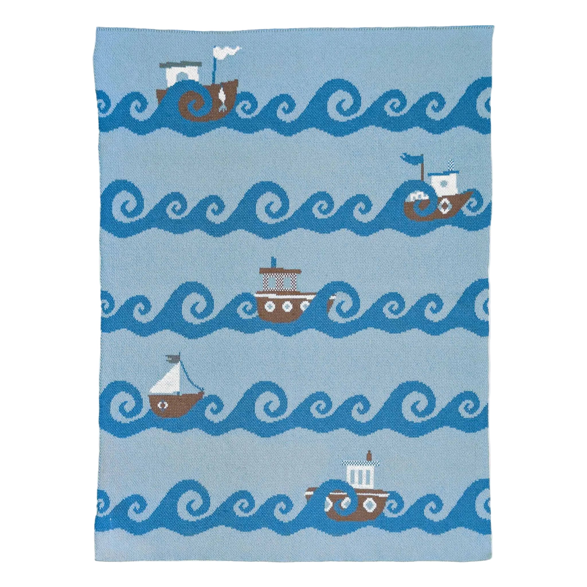 Blanket with boat and wave pattern on a blue background