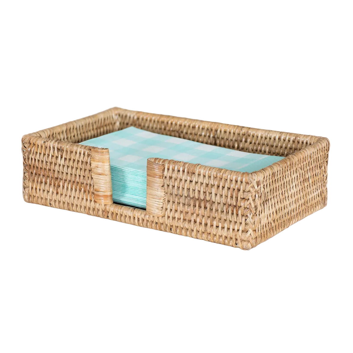 Woven napkin holder with turquoise napkins on a light surface.
