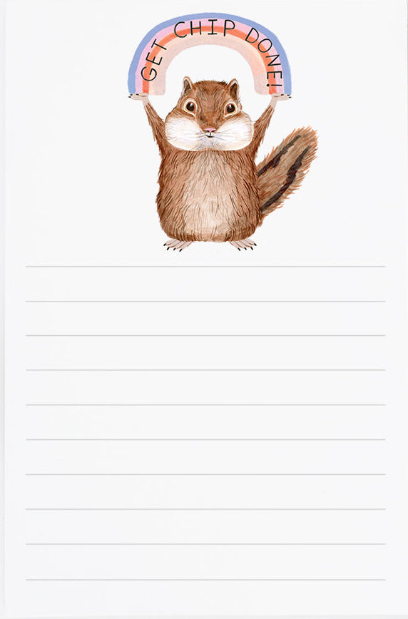 Notepad with a squirrel illustration and rainbow, next to a small seed packet on a white background.