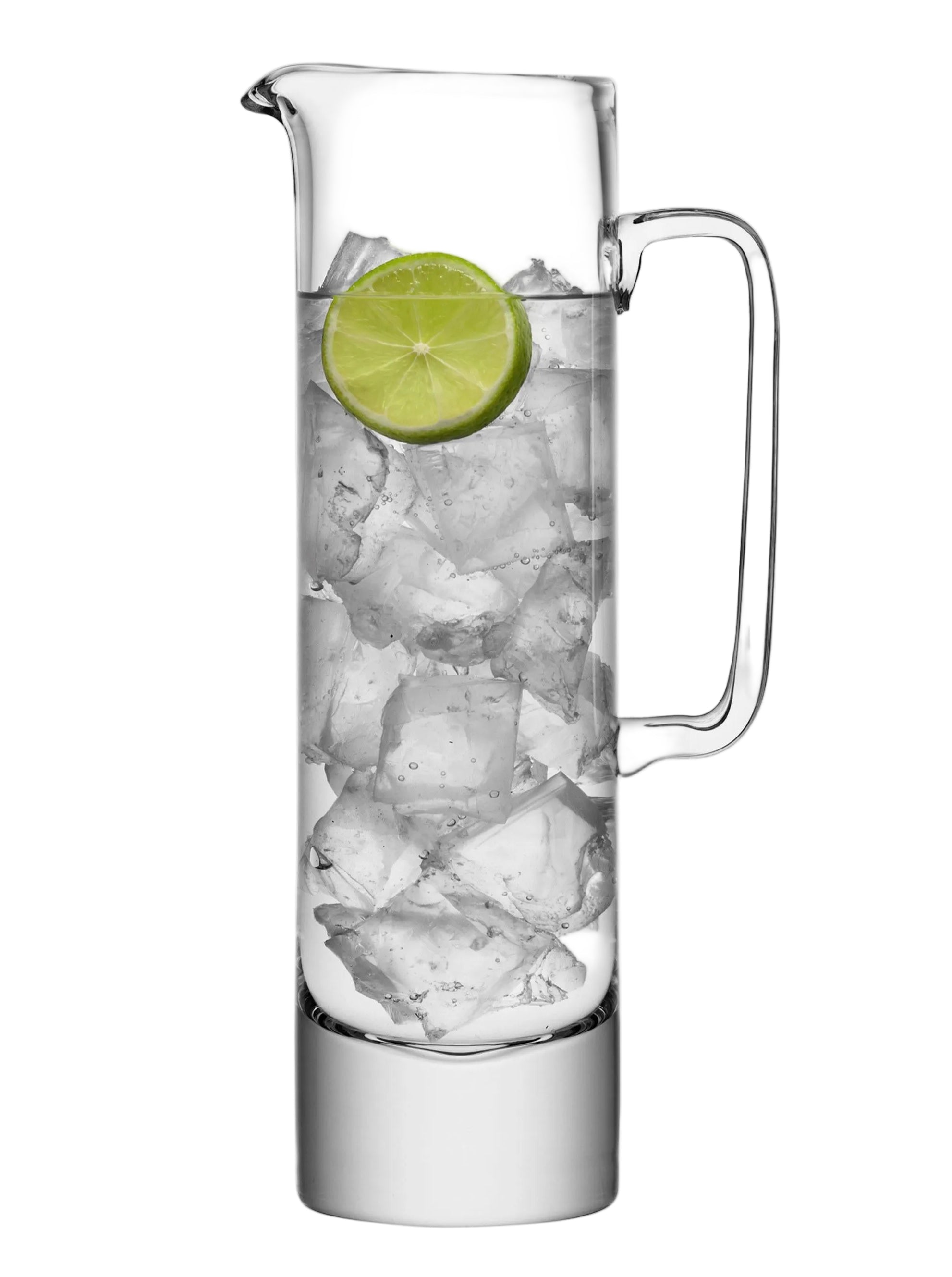 Clear glass pitcher filled with ice and a lime wedge on a white background
