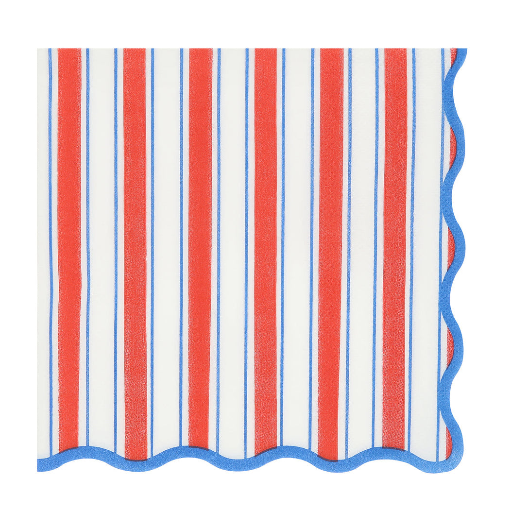 A square paper napkin with a vertical red, white, and blue stripe pattern and a scalloped blue edge, shown on a plain white background.