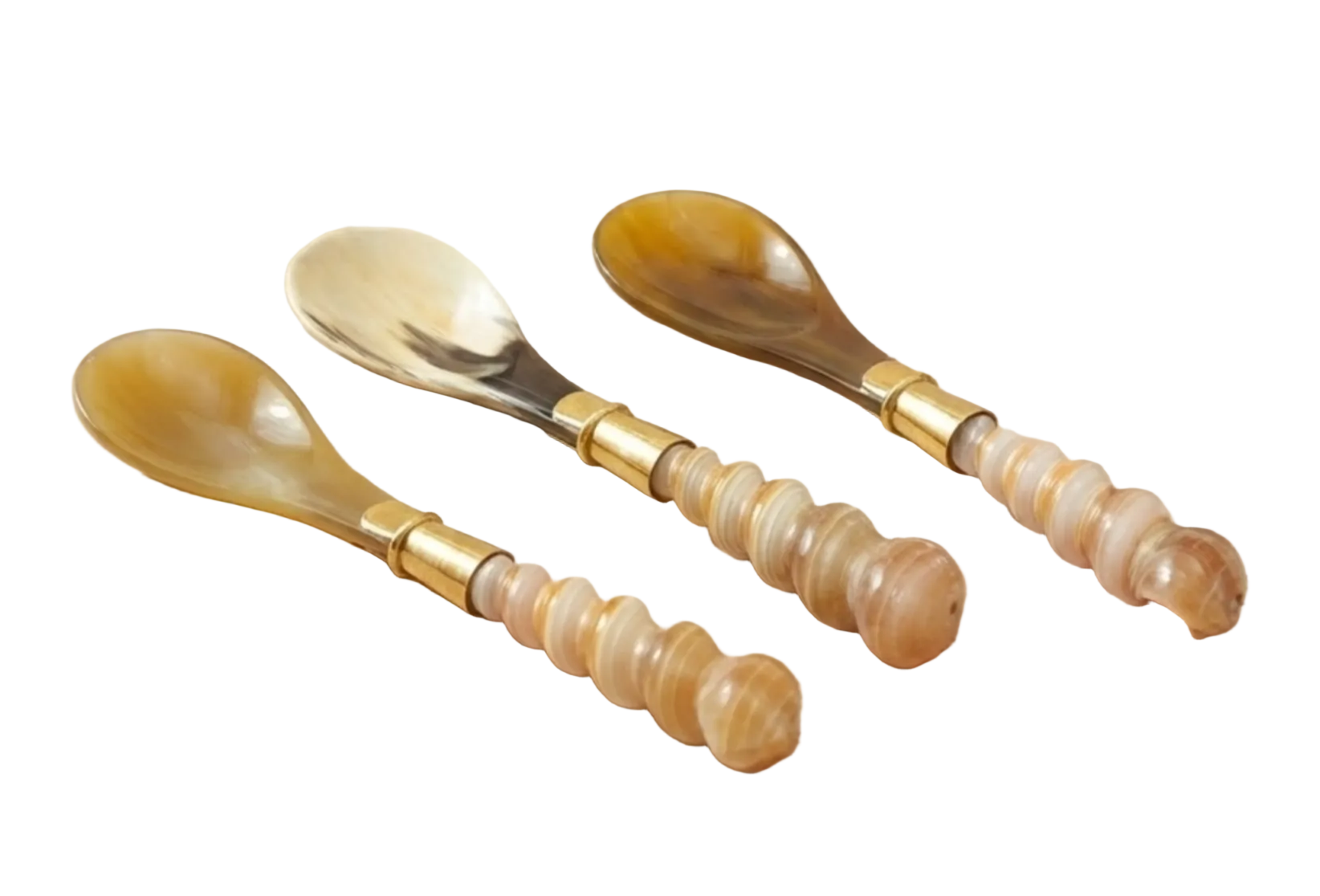 Set of three decorative spoons with gold accents on a wooden surface, next to a woven basket with dried plants.