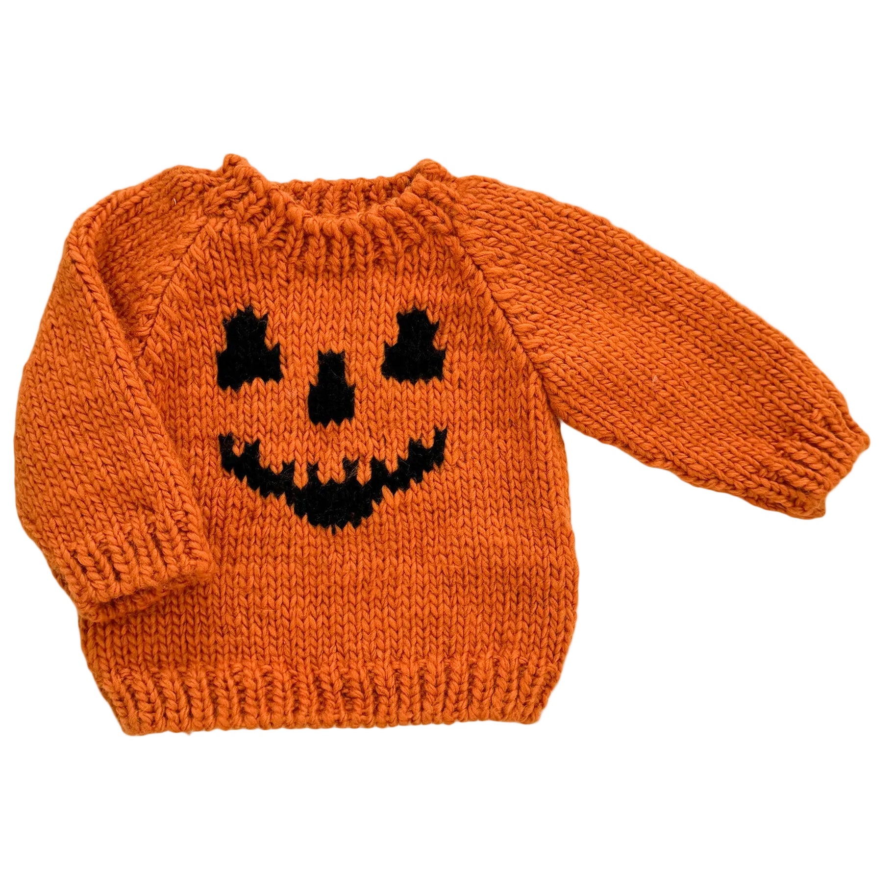 Orange knitted sweater with a black jack-o'-lantern face design on a white background