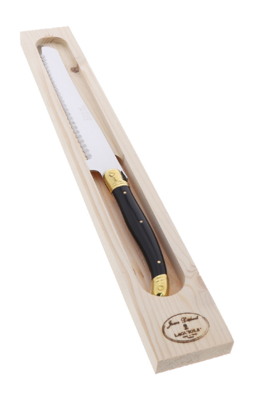Knife with black handle and gold accents in a wooden box on a white background