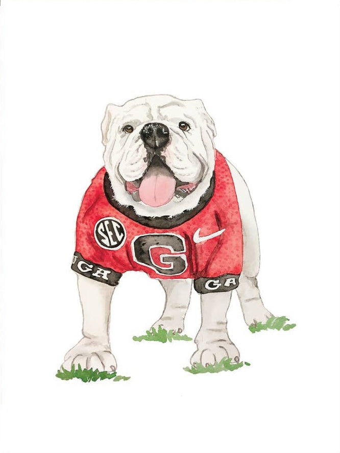 A greeting card featuring a watercolor illustration of a white bulldog wearing a red Georgia Bulldogs jersey, shown with a brown envelope on a white background.