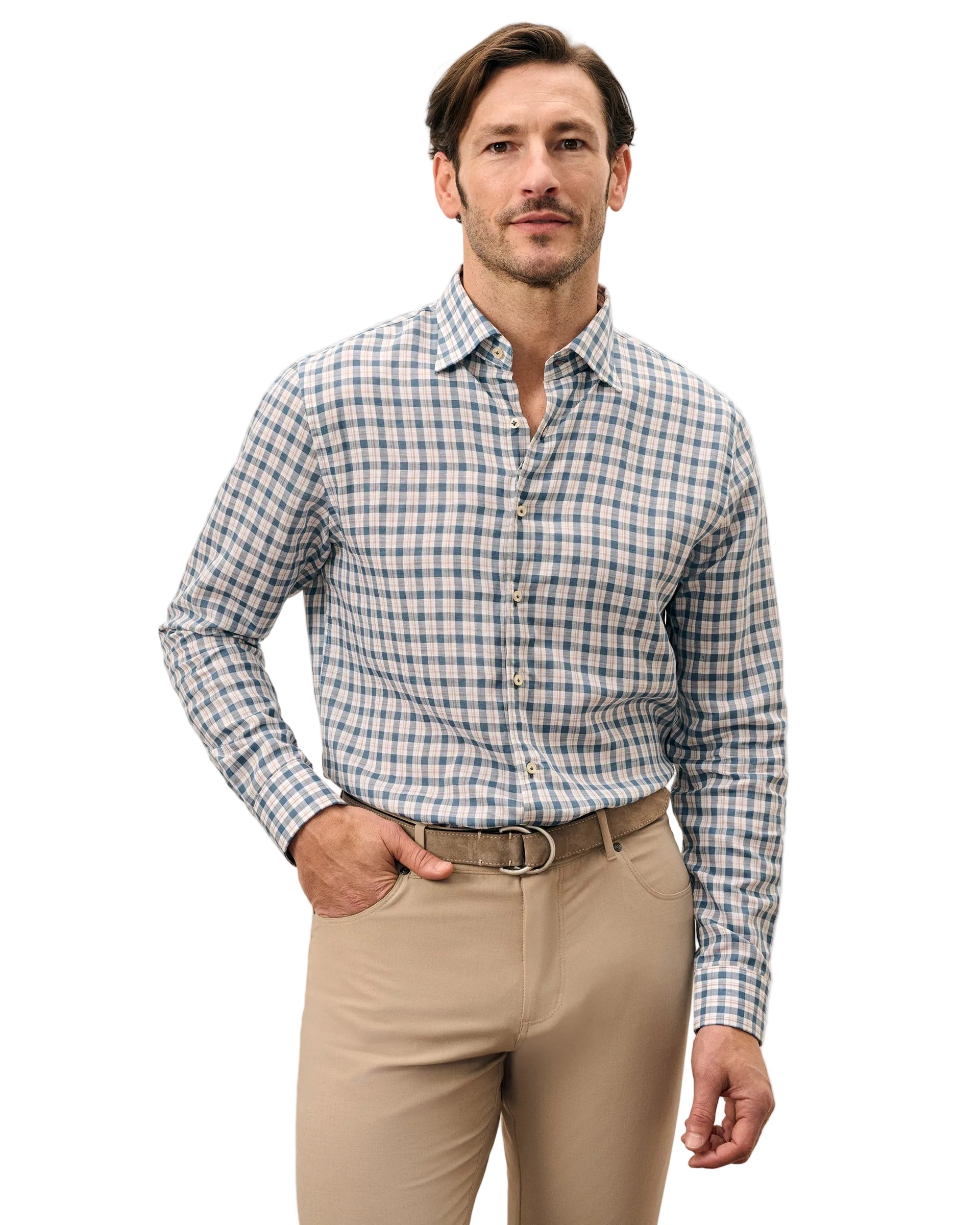 Man wearing a checkered shirt and beige pants against a light gray background