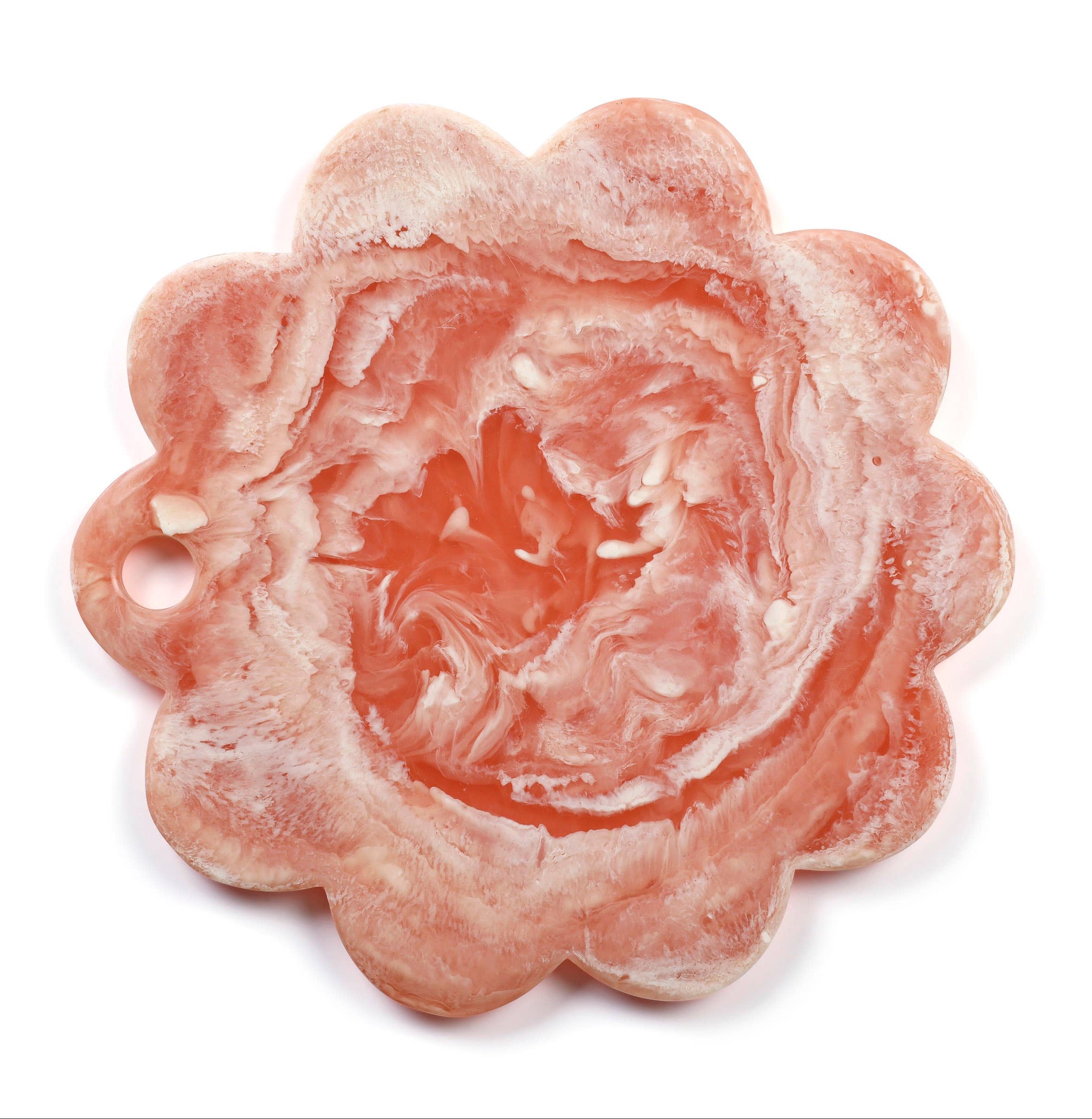 Pink flower-shaped object on a white background