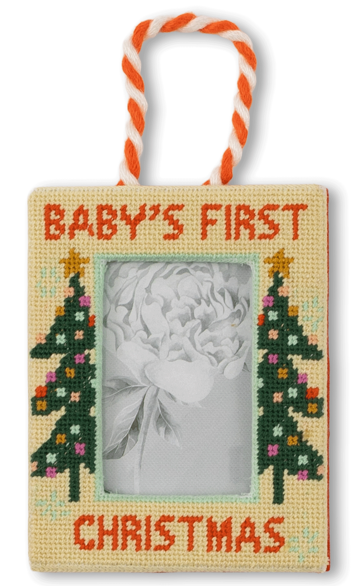 Decorative photo frame with 'Baby's First Christmas' text and Christmas tree designs on a white background.