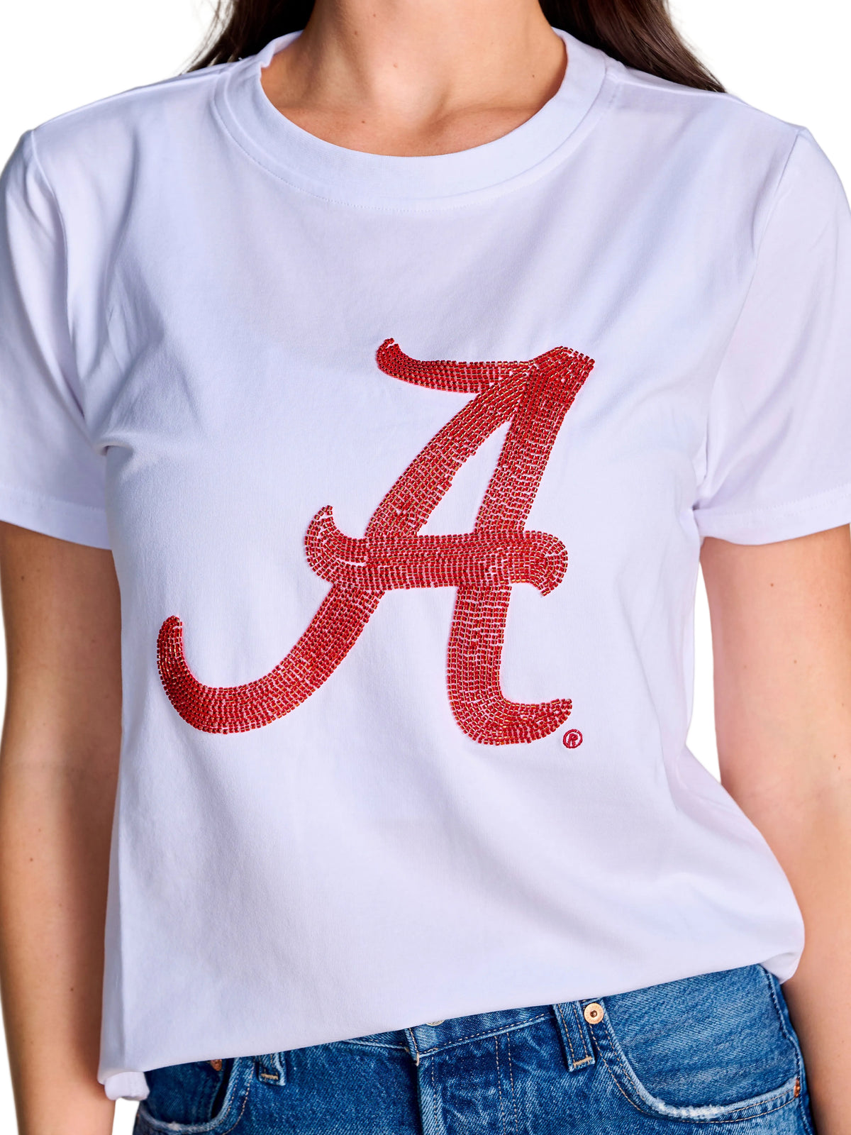 A white short-sleeve crewneck t-shirt featuring a large red textured script letter 'A' for Alabama on the front, worn by a model with blue jeans visible at the bottom.