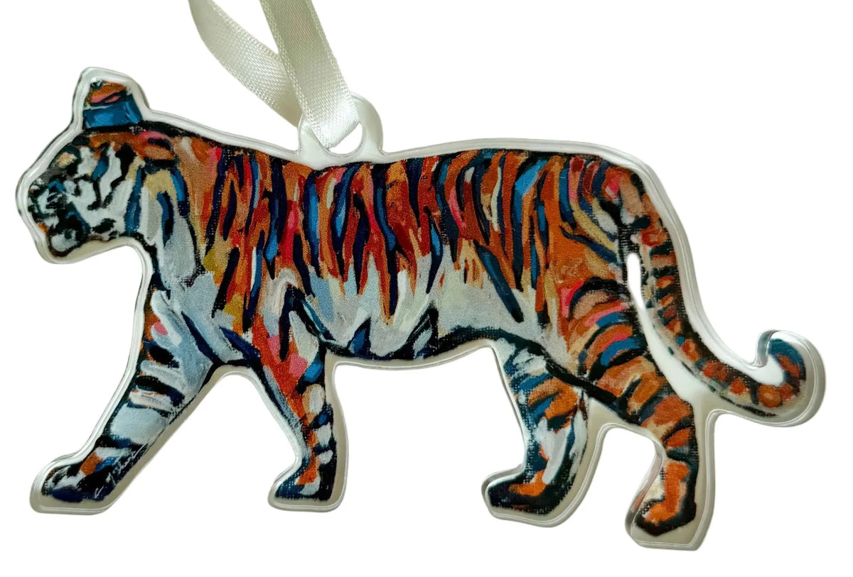Decorative tiger ornament with a white ribbon on a light gray background