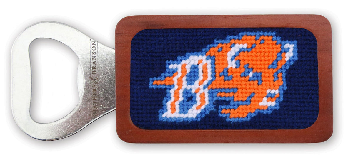 A rectangular bottle opener with a brown wood-grain frame and a silver metal lever, featuring a navy blue needlepoint patch with an orange and white tiger head logo.