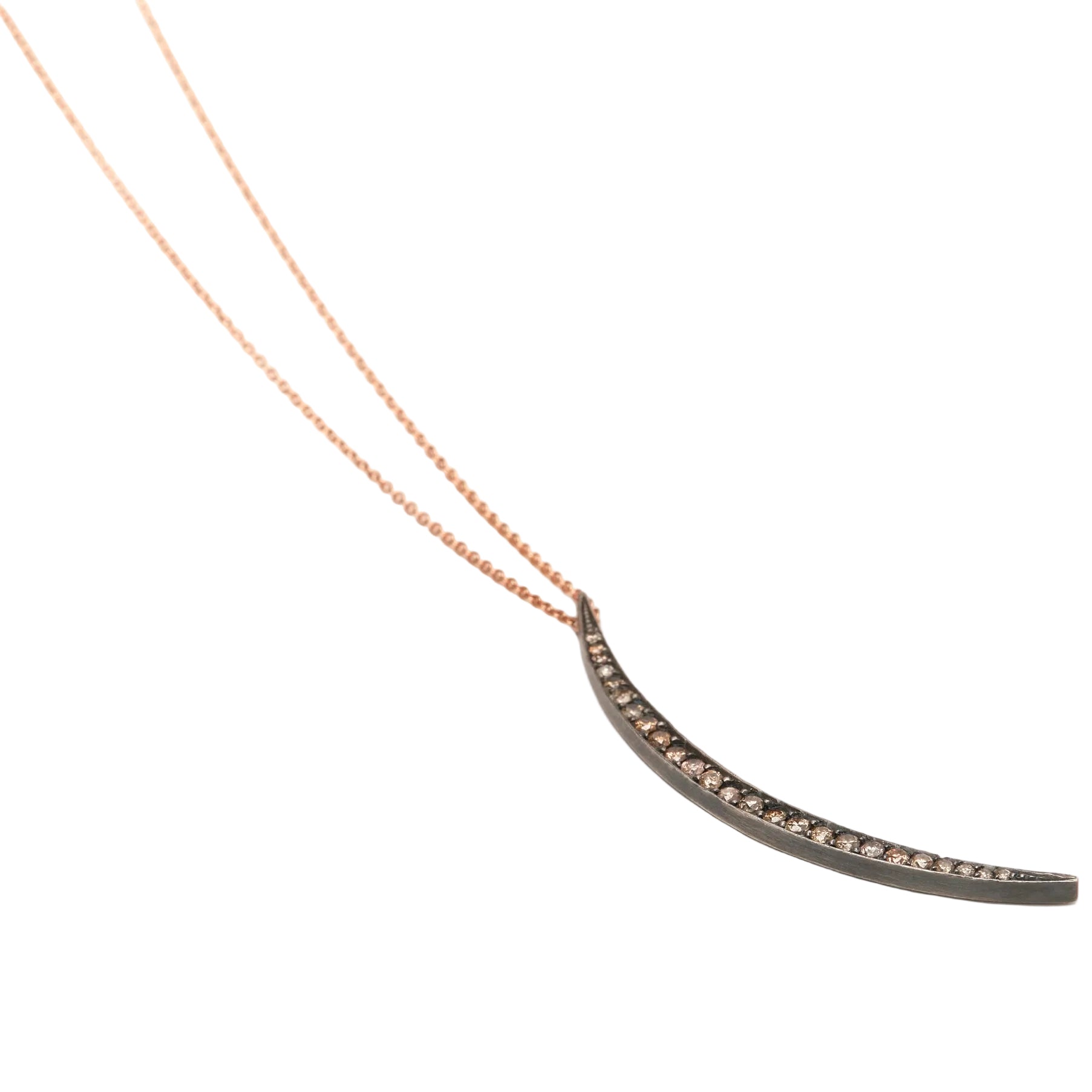 Crescent-shaped necklace with rose gold chain on a white background