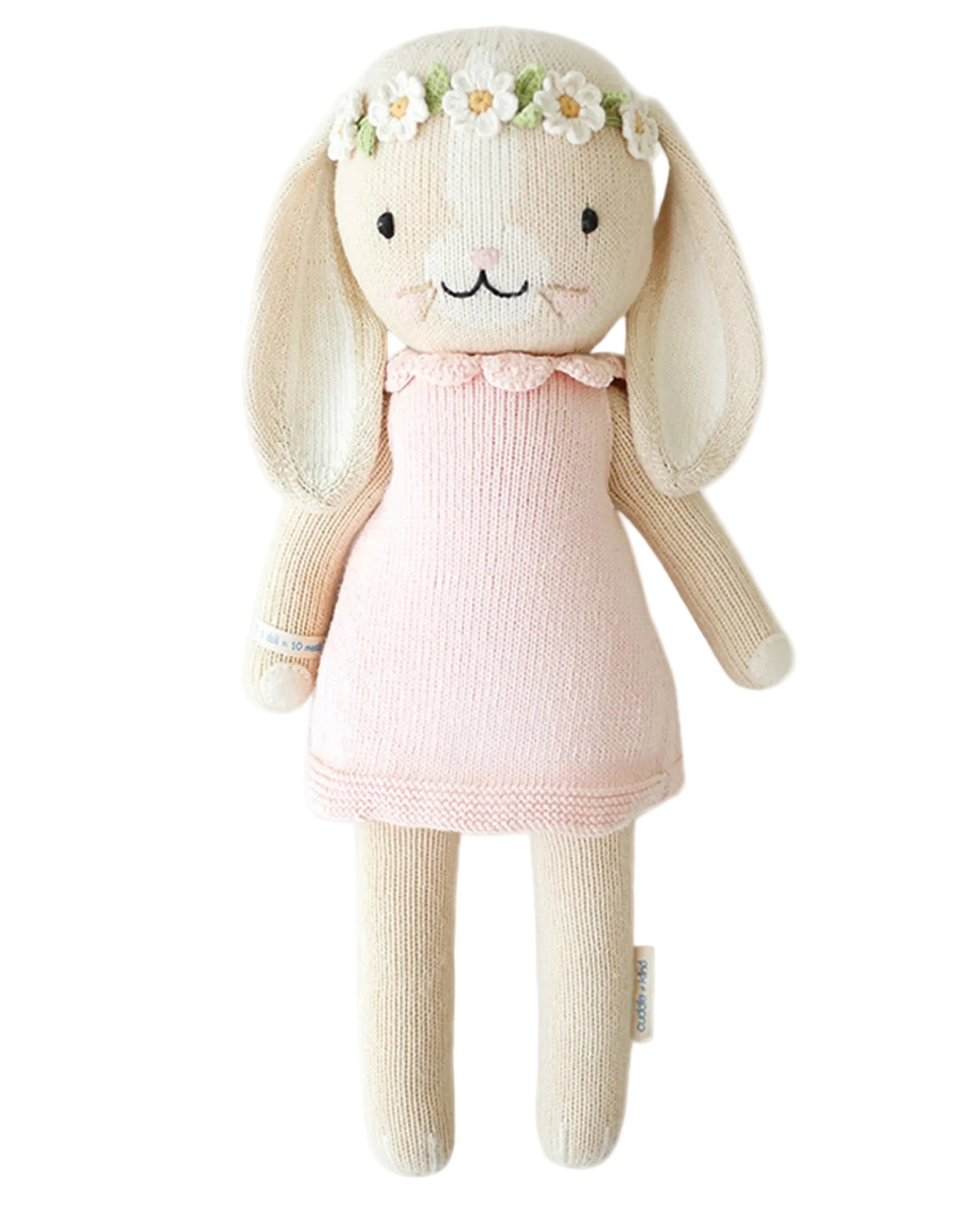 Plush toy rabbit with a pink dress and flower crown on a white background