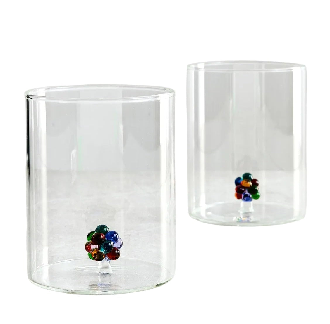 Two clear glass tumblers with colorful flower designs on a white background