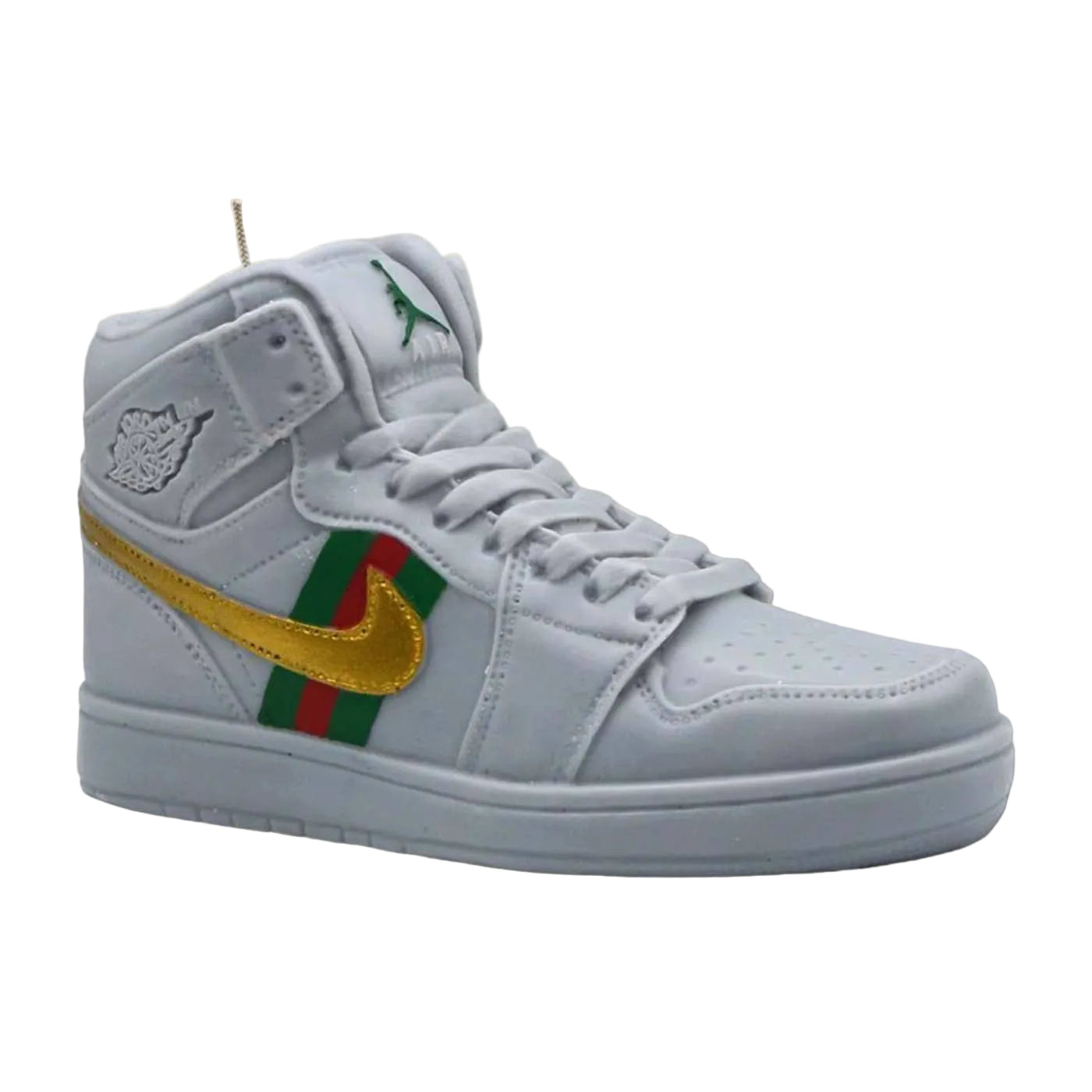 grey sneaker with gold, green, and red accents on a beige background