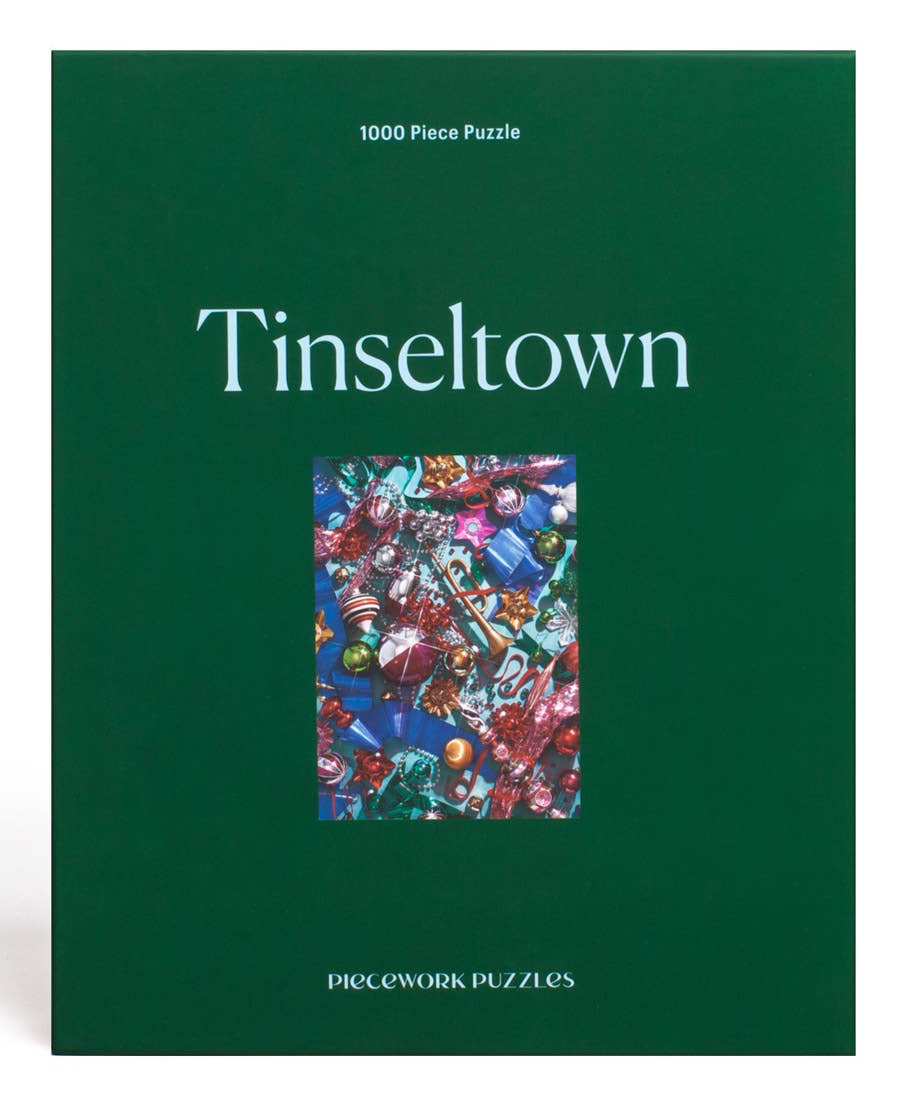 A 1000-piece jigsaw puzzle box for 'Tinseltown' by Drekowagi Puzzles, featuring a solid dark green cover with white text and a colorful central image of a tinsley town scene.