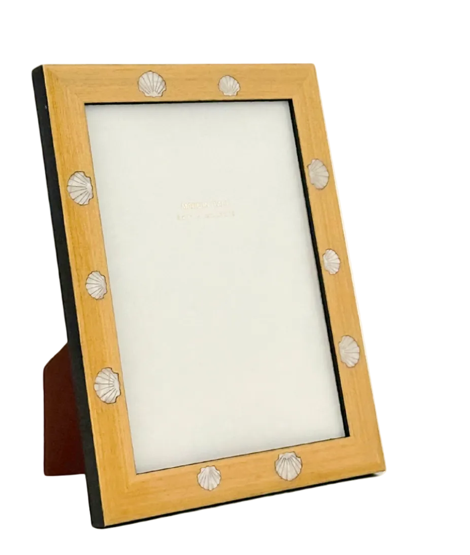 Wooden picture frame with decorative elements on a beige background