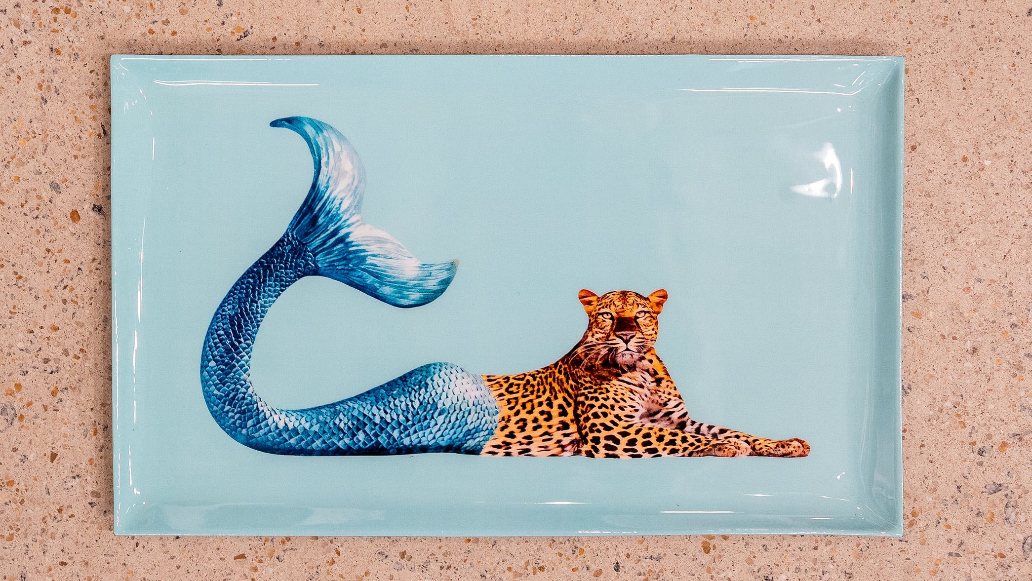 Rectangular card with a leopard and mermaid tail design on a textured beige background