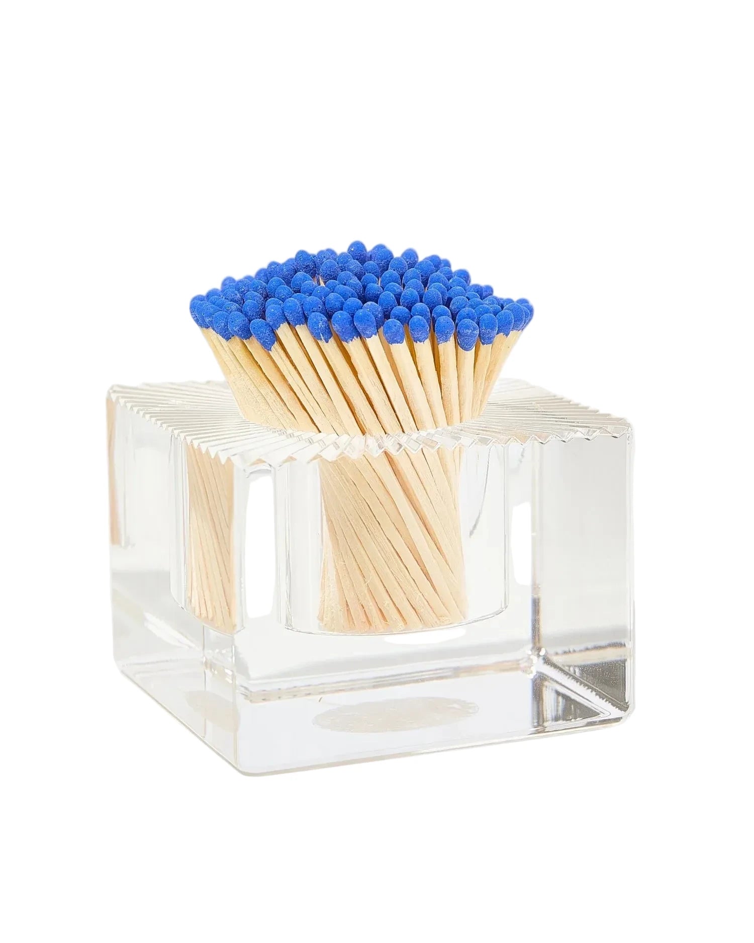 Clear glass matchbox with blue matches on a white background