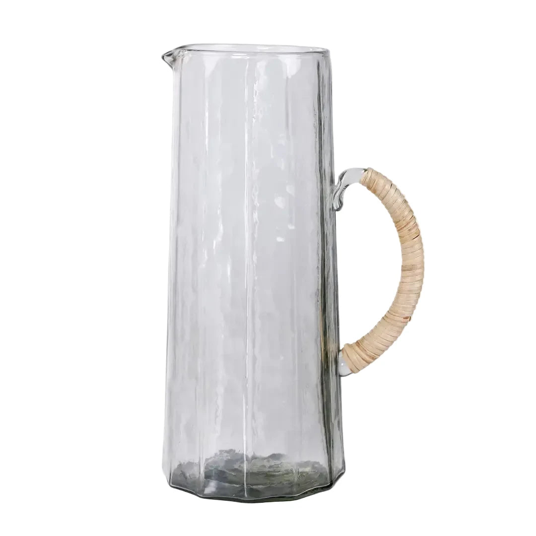 Clear glass pitcher with a wooden handle on a white background