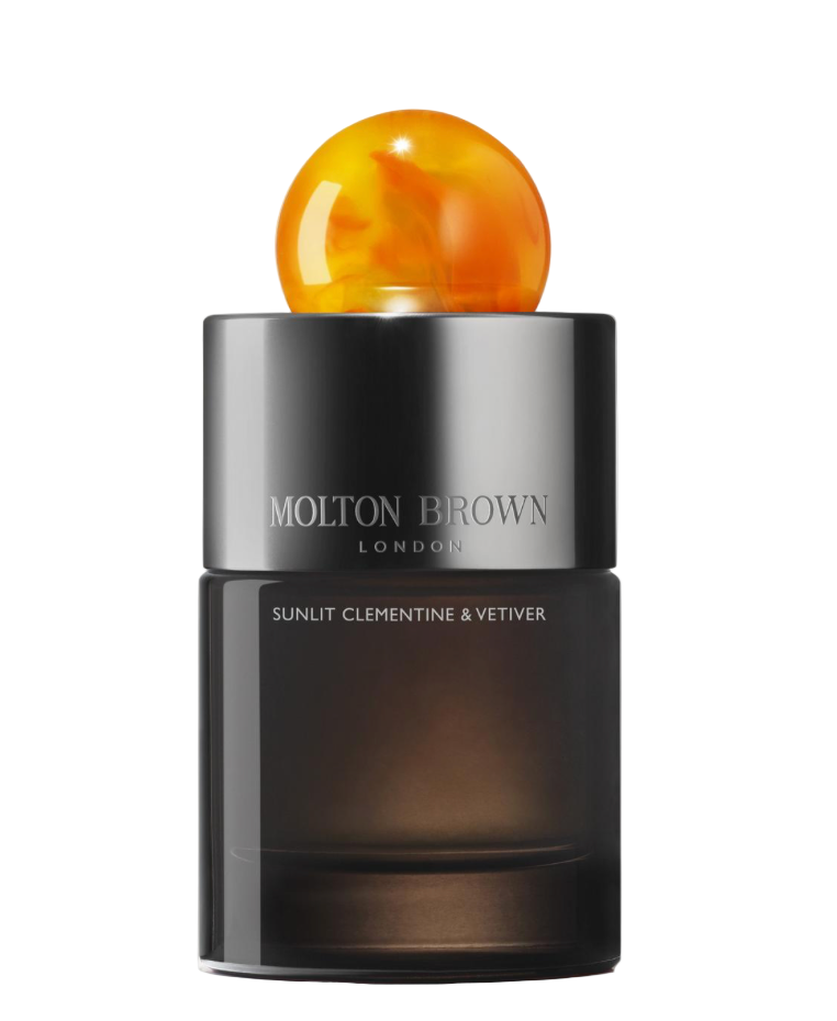 Molton Brown perfume bottle with a spherical orange cap on a white background