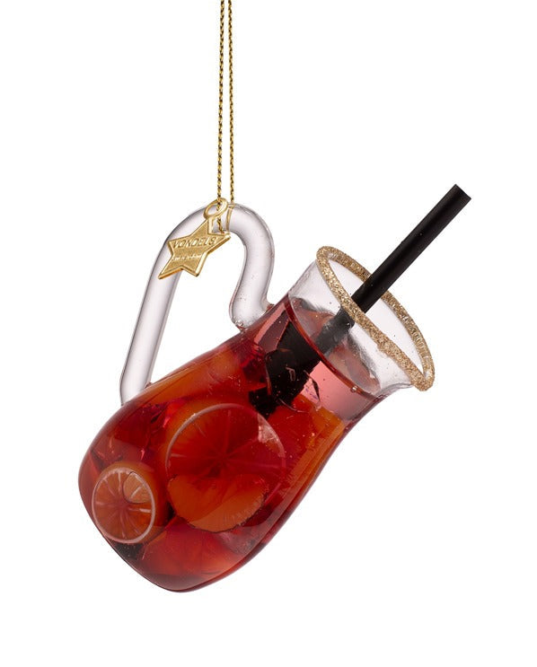 Decorative glass drink ornament with a straw on a white background