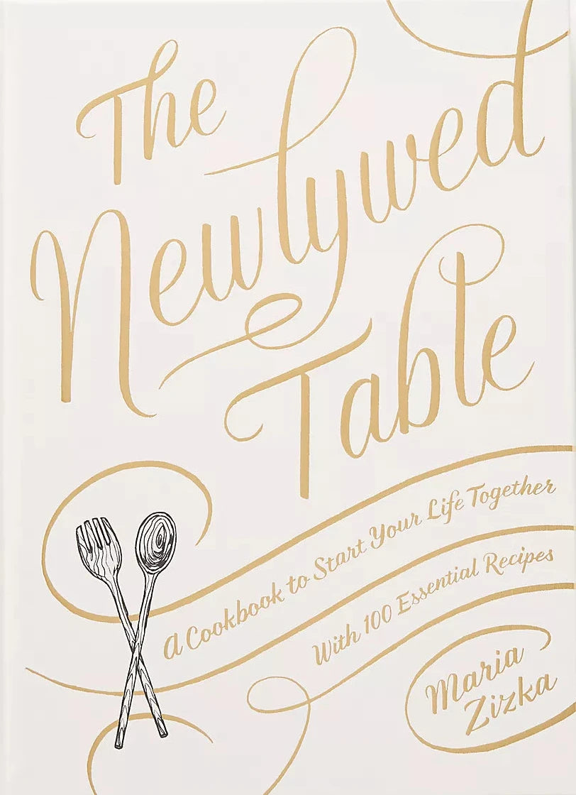 Cookbook titled 'The Newlywed Table' with gold text on a white background
