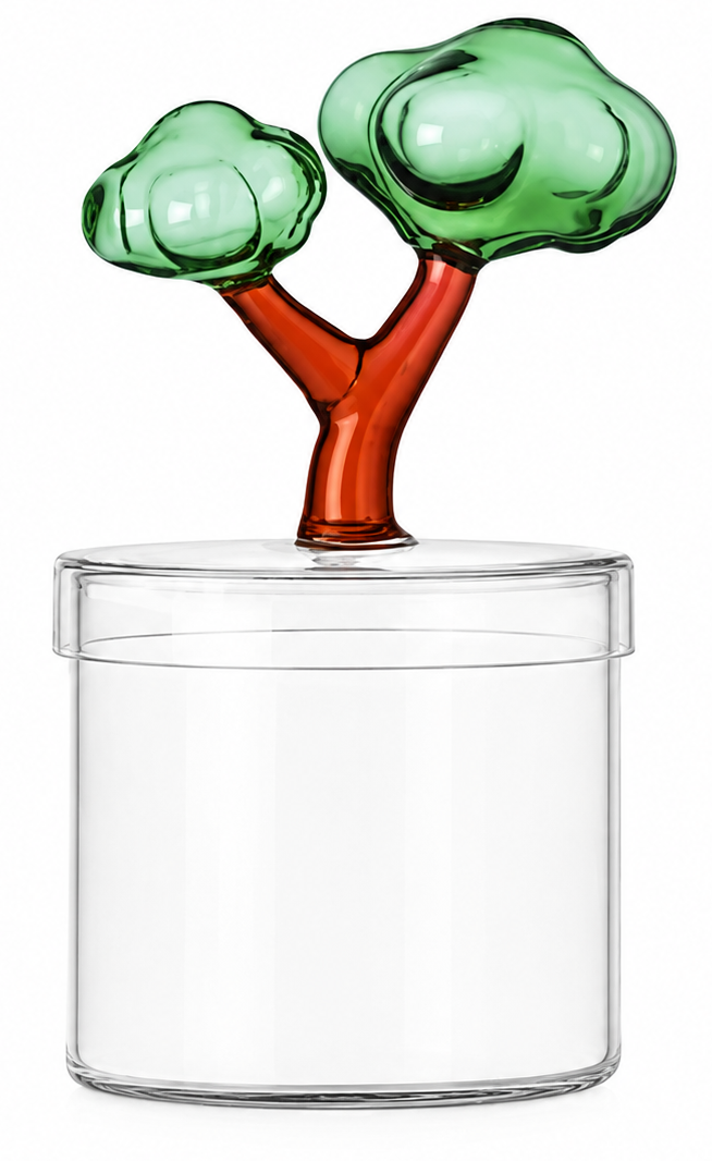 A clear cylindrical glass container with a lid, topped by a decorative tree-shaped handle featuring translucent green glass foliage and a reddish-brown stem, shown on a white background.
