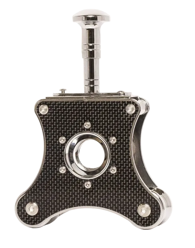 A stainless steel table cigar cutter with a carbon fiber pattern on the side and a black knob handle on top.