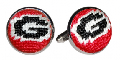 Cufflinks with a red, white, and black design on a white background