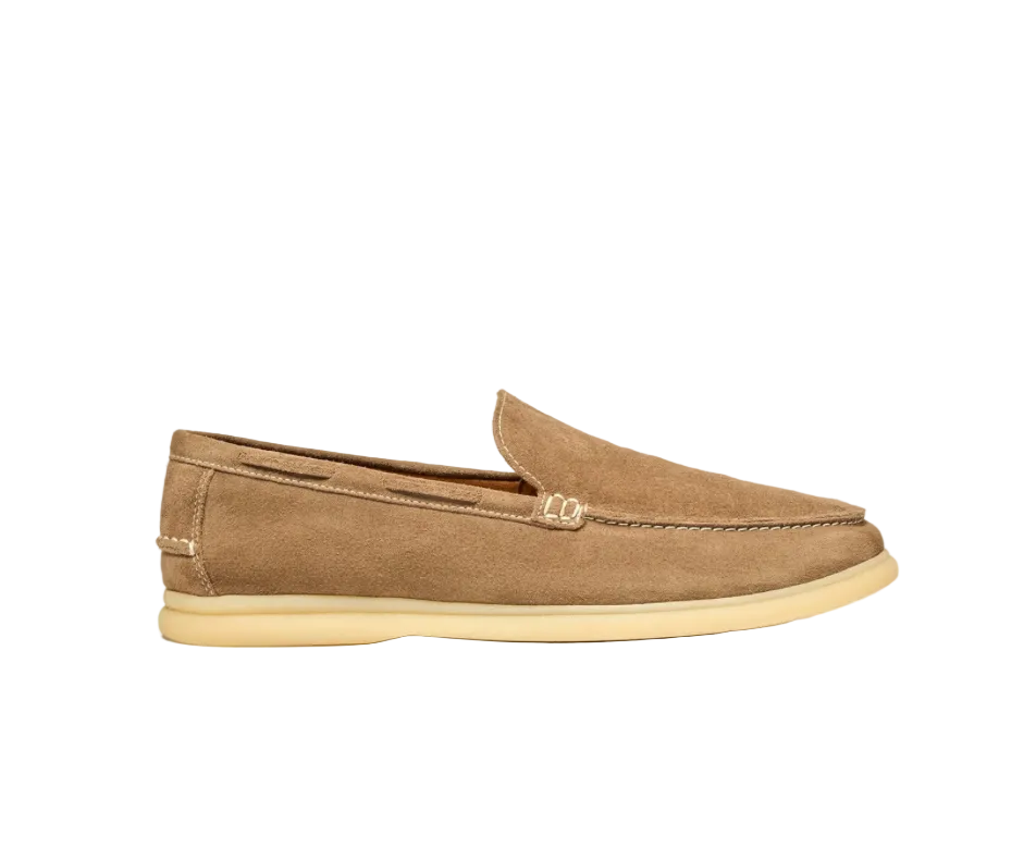 Beige loafer shoe on a light beige background
