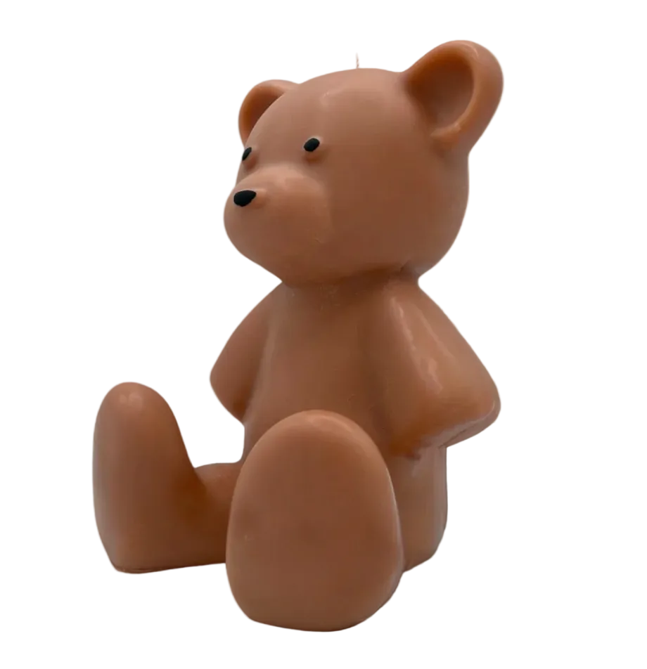 Brown teddy bear candle on a beige background