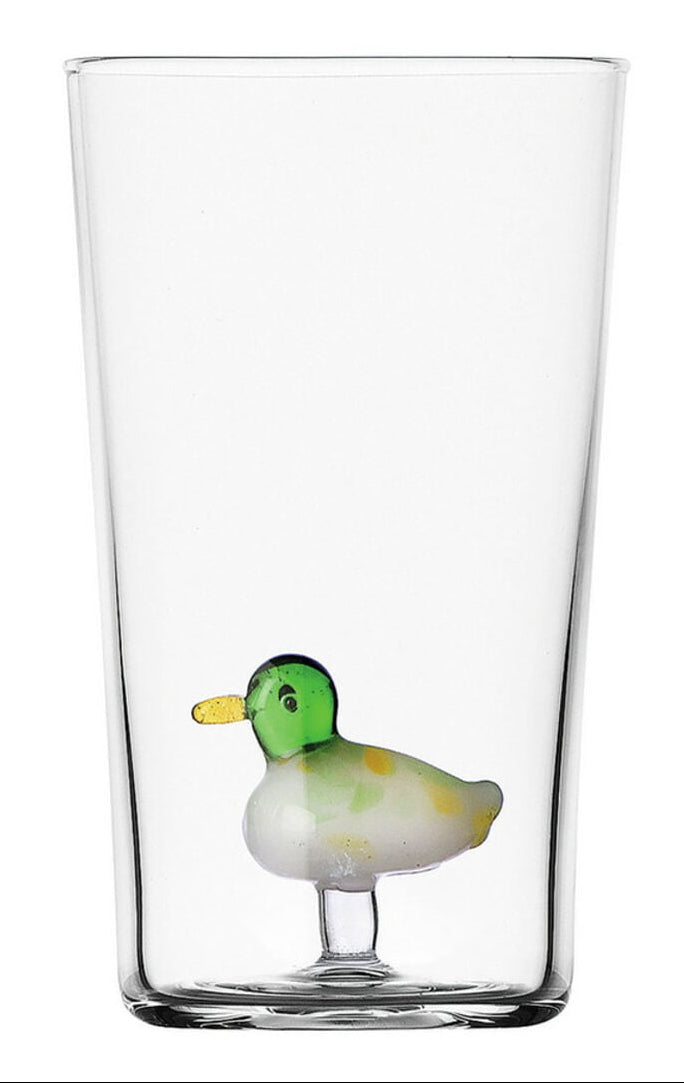 A clear double-walled glass tumbler featuring a small, colorful duck figurine at the base. The duck has a green head, yellow beak, white body, and yellow spots, set against a solid white background.