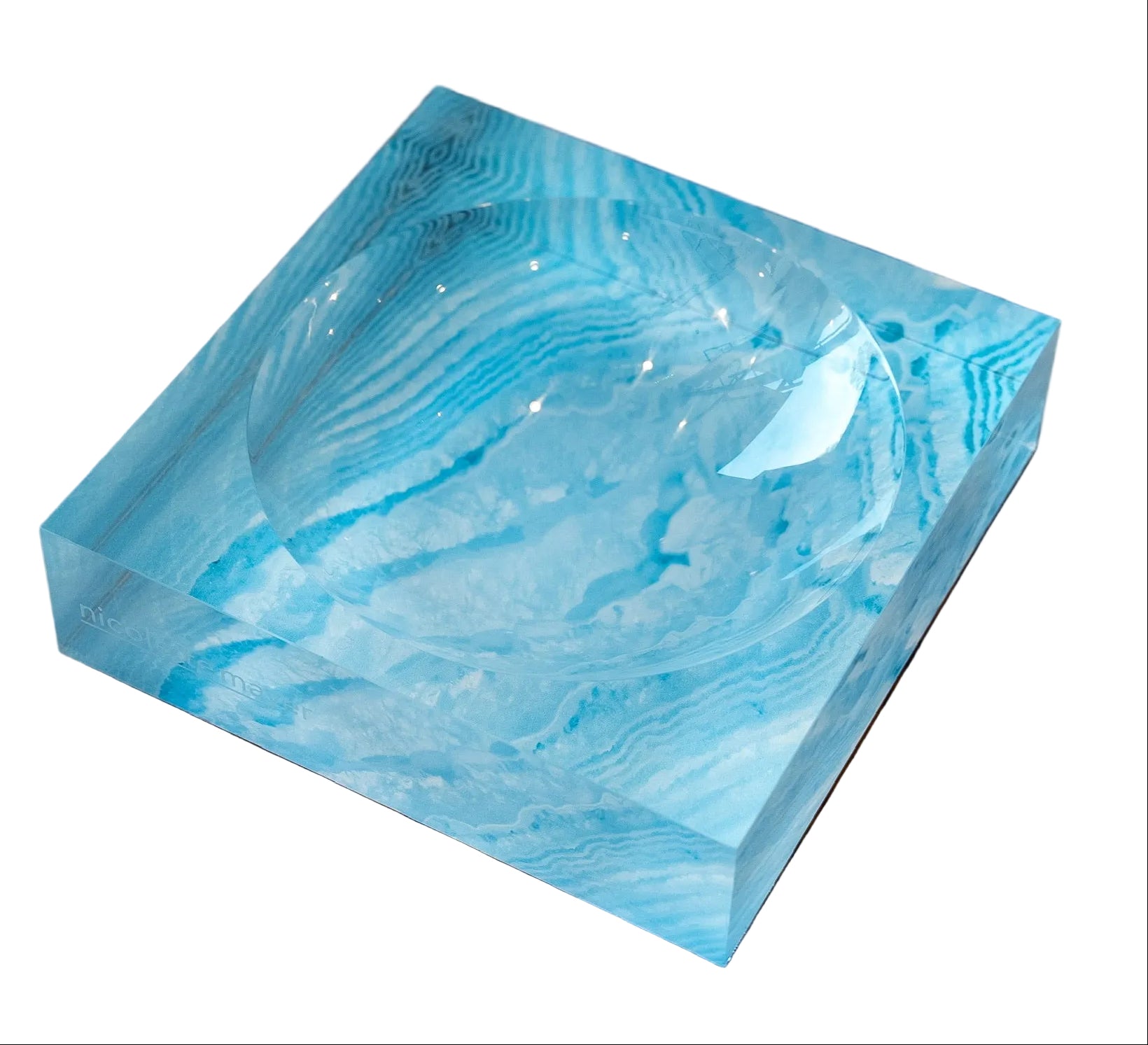 Blue marbled rectangular tray on a wooden surface with a blurred background