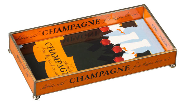 A rectangular orange-colored glass tray with 'Champagne' text and glasses illustrated on the top surface.