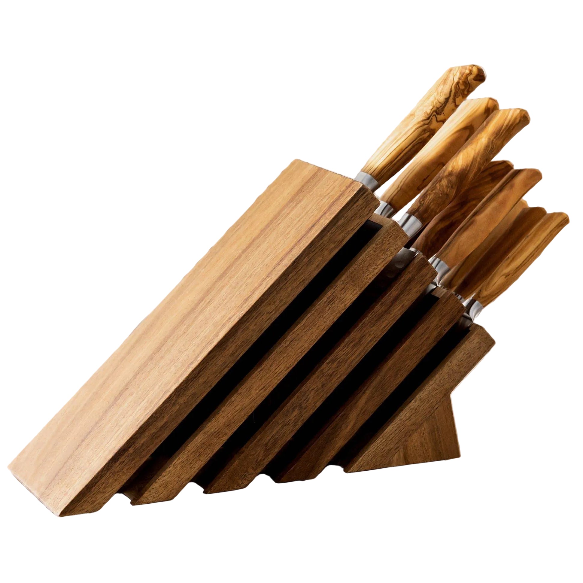 Set of knives in a wooden block on a light surface with a textured white background