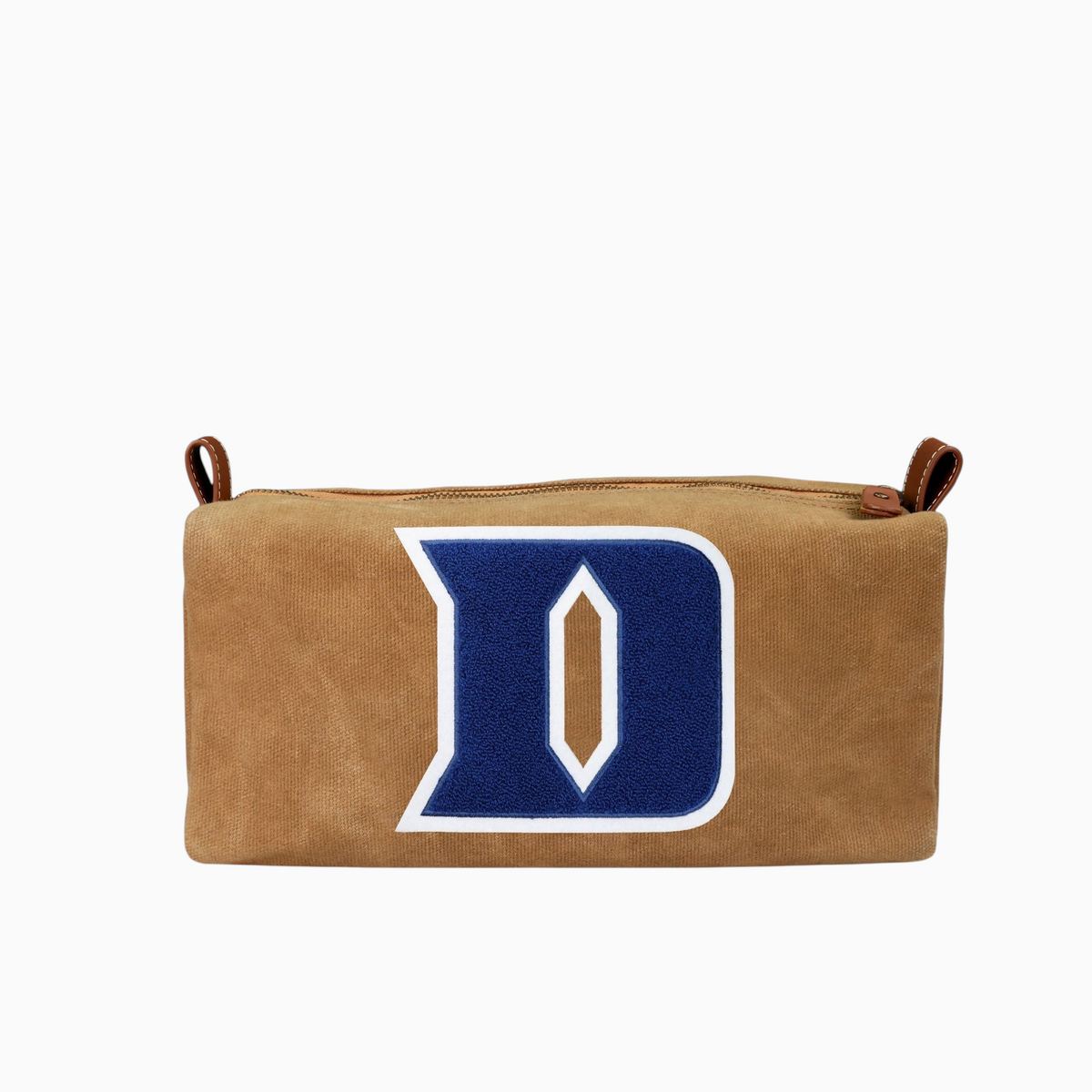 Miller Collective Duke Iron D canvas dopp kit in tan with blue chenille patch, leather trim, and brass hardware.