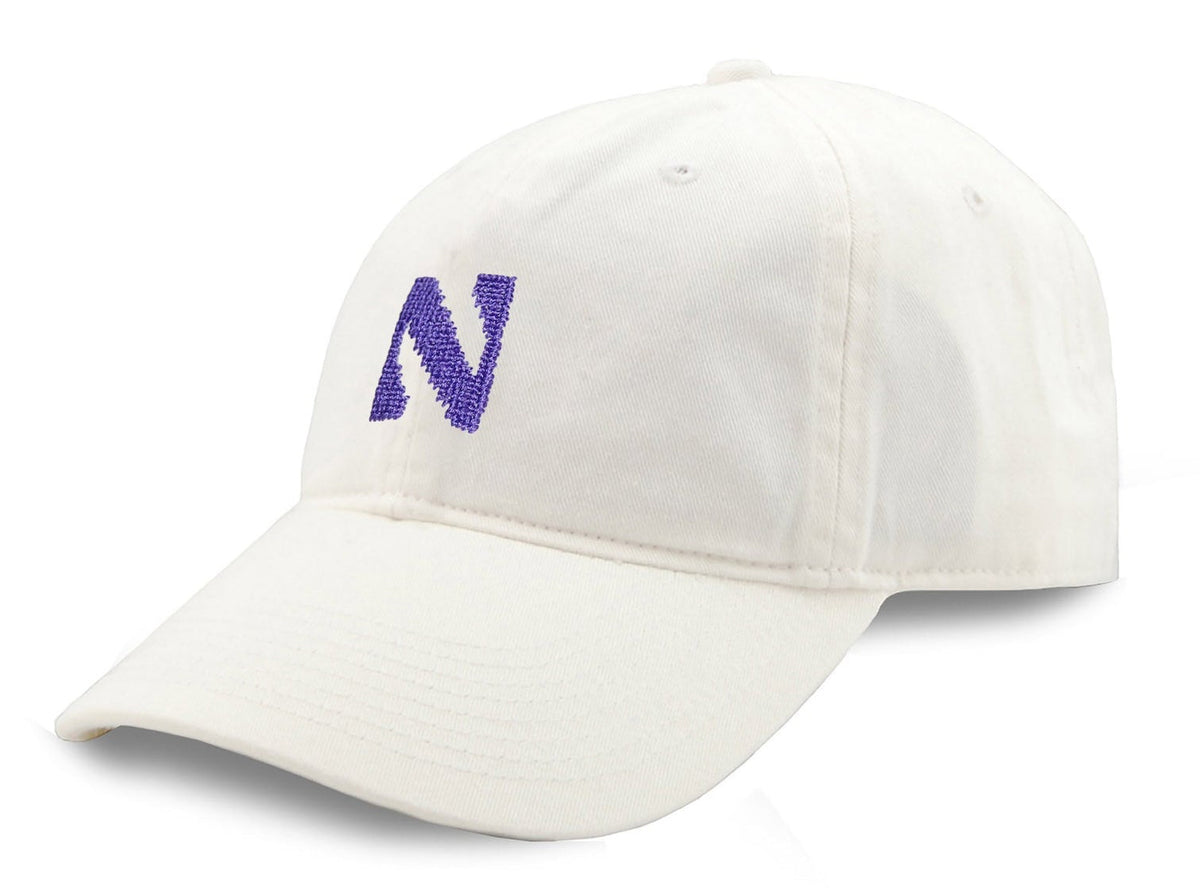 White cap with purple logo on a white background