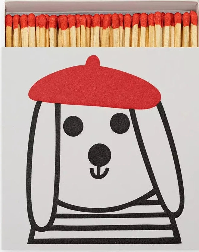 Matches with a dog illustration and red cap on a white background